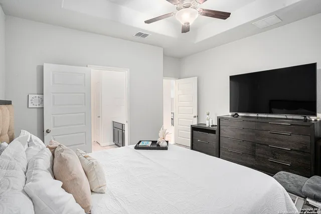 a bedroom with a bed and a flat screen tv