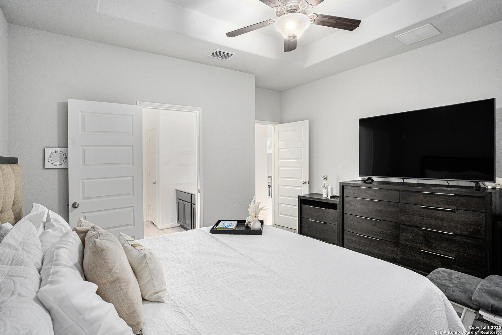 16615 Ginger Crossing Elmendorf, TX 78112 - Photo 12 of 31 a bedroom with a bed and a flat screen tv