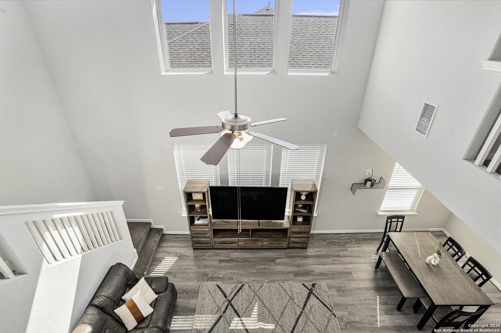 16615 Ginger Crossing Elmendorf, TX 78112 - Photo 14 of 31 a living room with furniture a flat screen tv and a fireplace