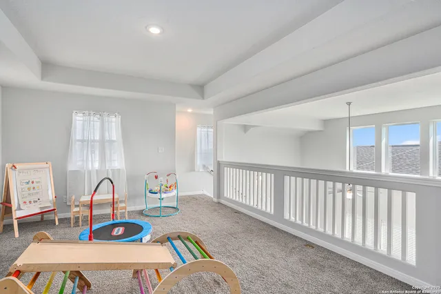 a living room with furniture a flat screen tv and a table