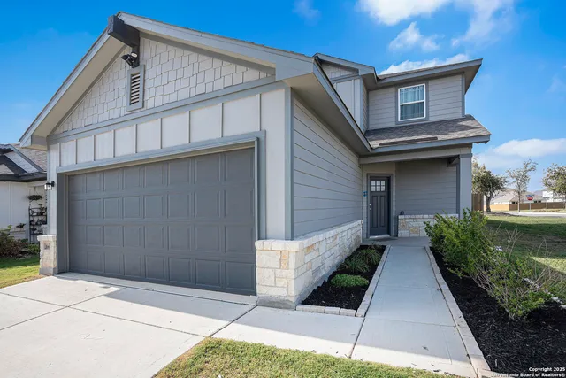 a front view of a house with garage
