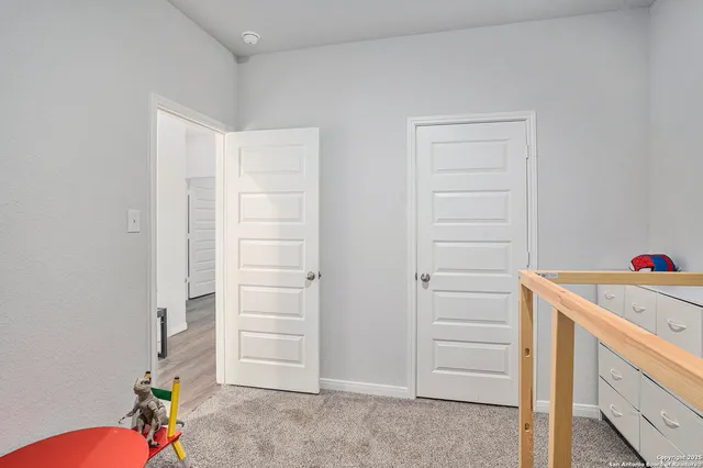 a bedroom with a bed and a night stand