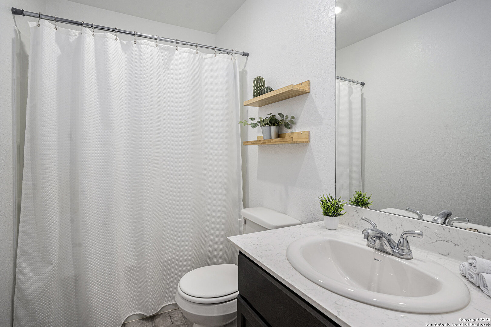 16615 Ginger Crossing Elmendorf, TX 78112 - Photo 24 of 31 a bathroom with a sink and a mirror