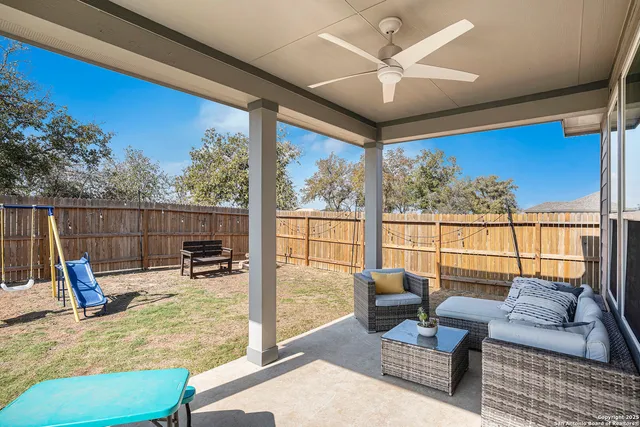 a view of a house with wooden fence