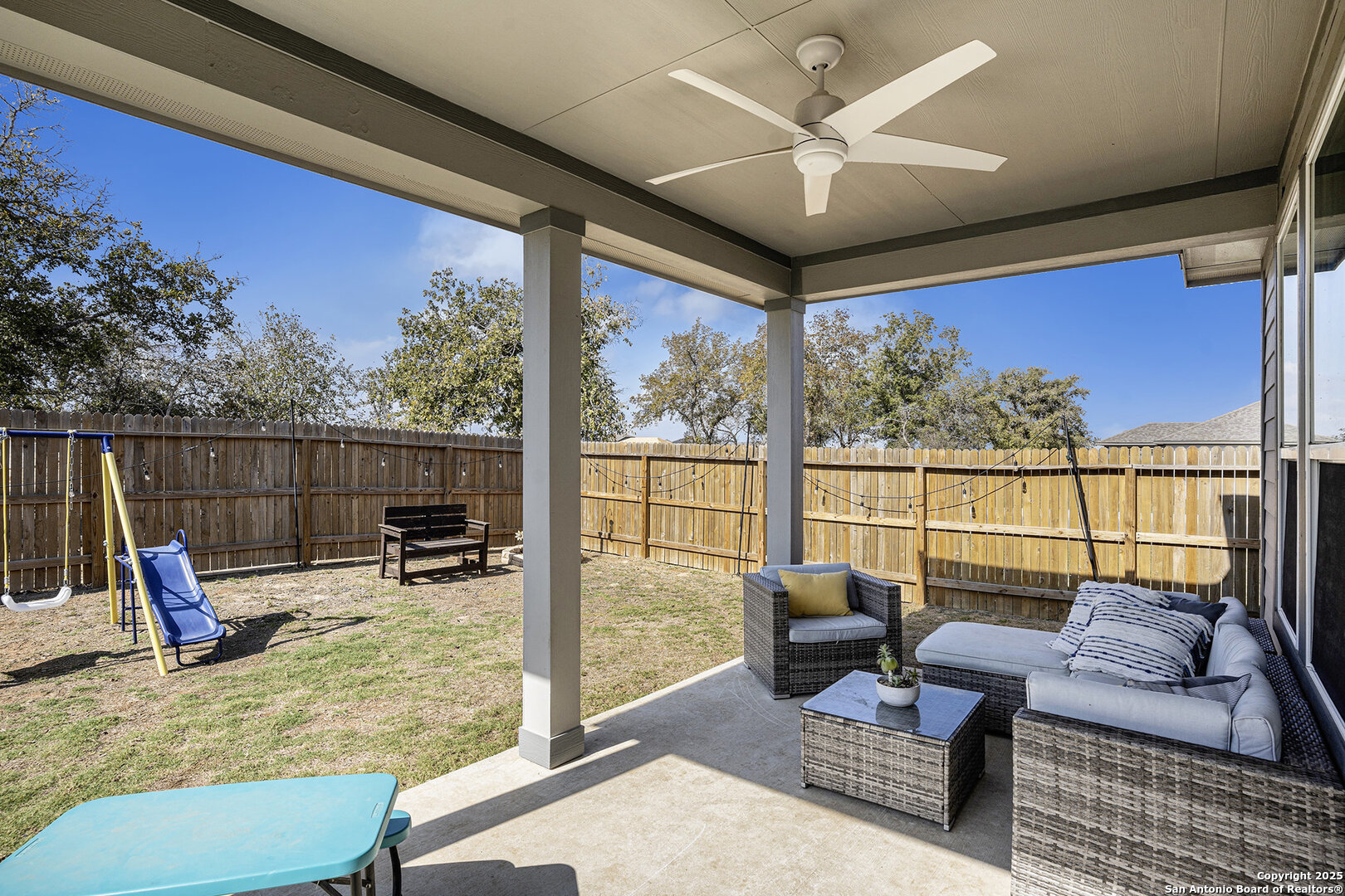 16615 Ginger Crossing Elmendorf, TX 78112 - Photo 26 of 31 a living room with furniture a rug and a large window