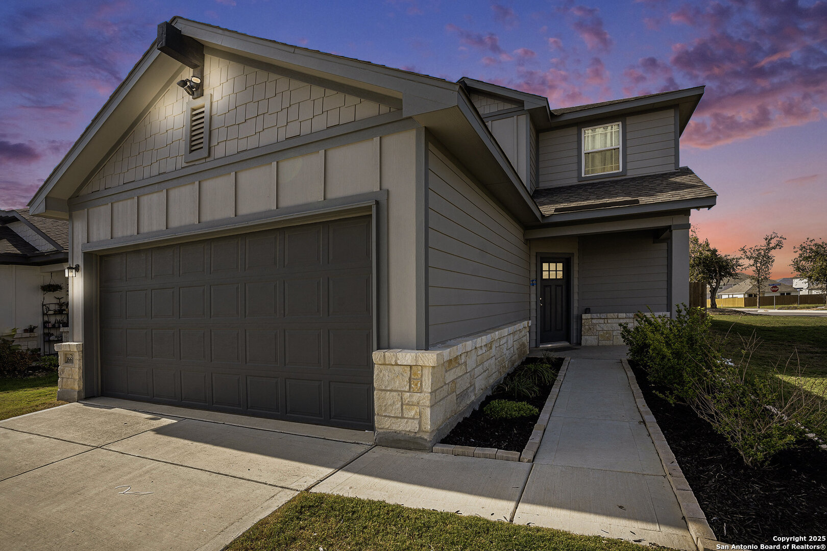 16615 Ginger Crossing Elmendorf, TX 78112 - Photo 30 of 31 a front view of a house with a garden