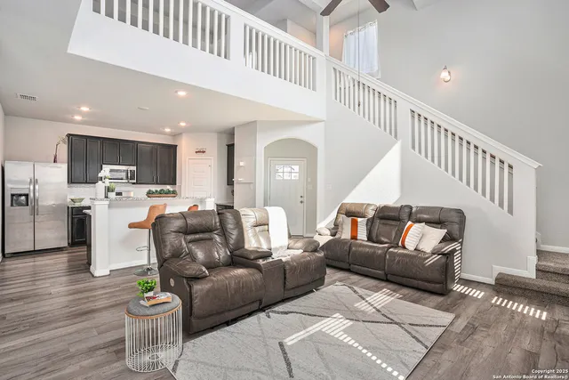 a living room with furniture and kitchen view