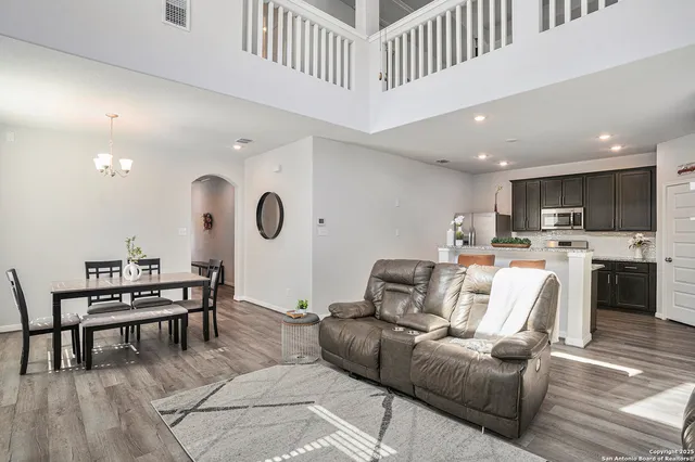 a living room with furniture and kitchen view