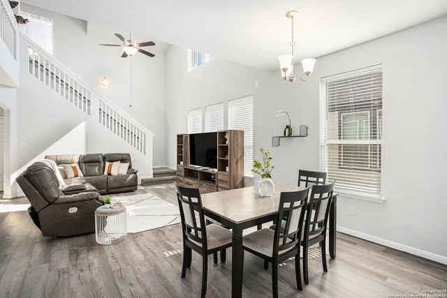 a living room with furniture a flat screen tv and a window