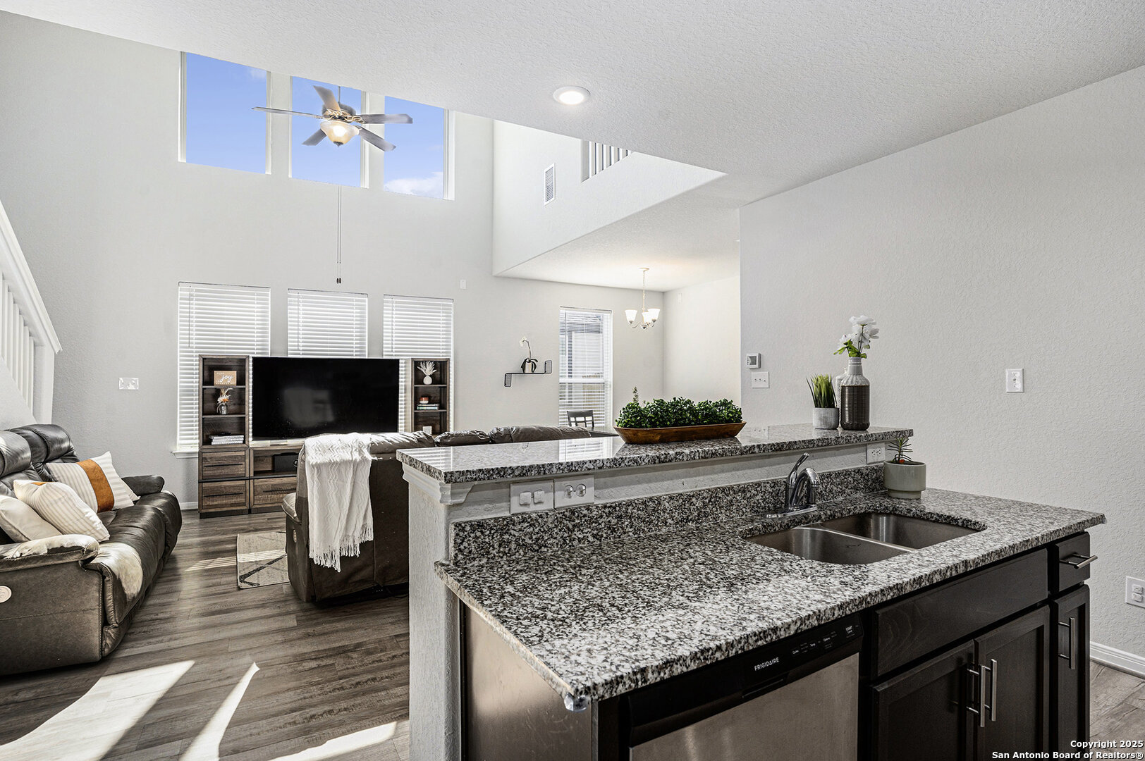 16615 Ginger Crossing Elmendorf, TX 78112 - Photo 10 of 31 a kitchen with a sink and a stove top oven with wooden floor