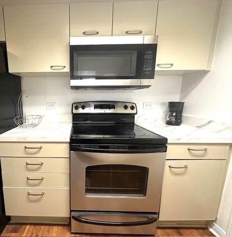 a stove top oven sitting inside of a kitchen