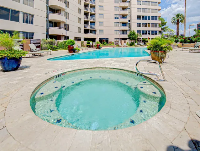 a view of a swimming pool with outdoor seating