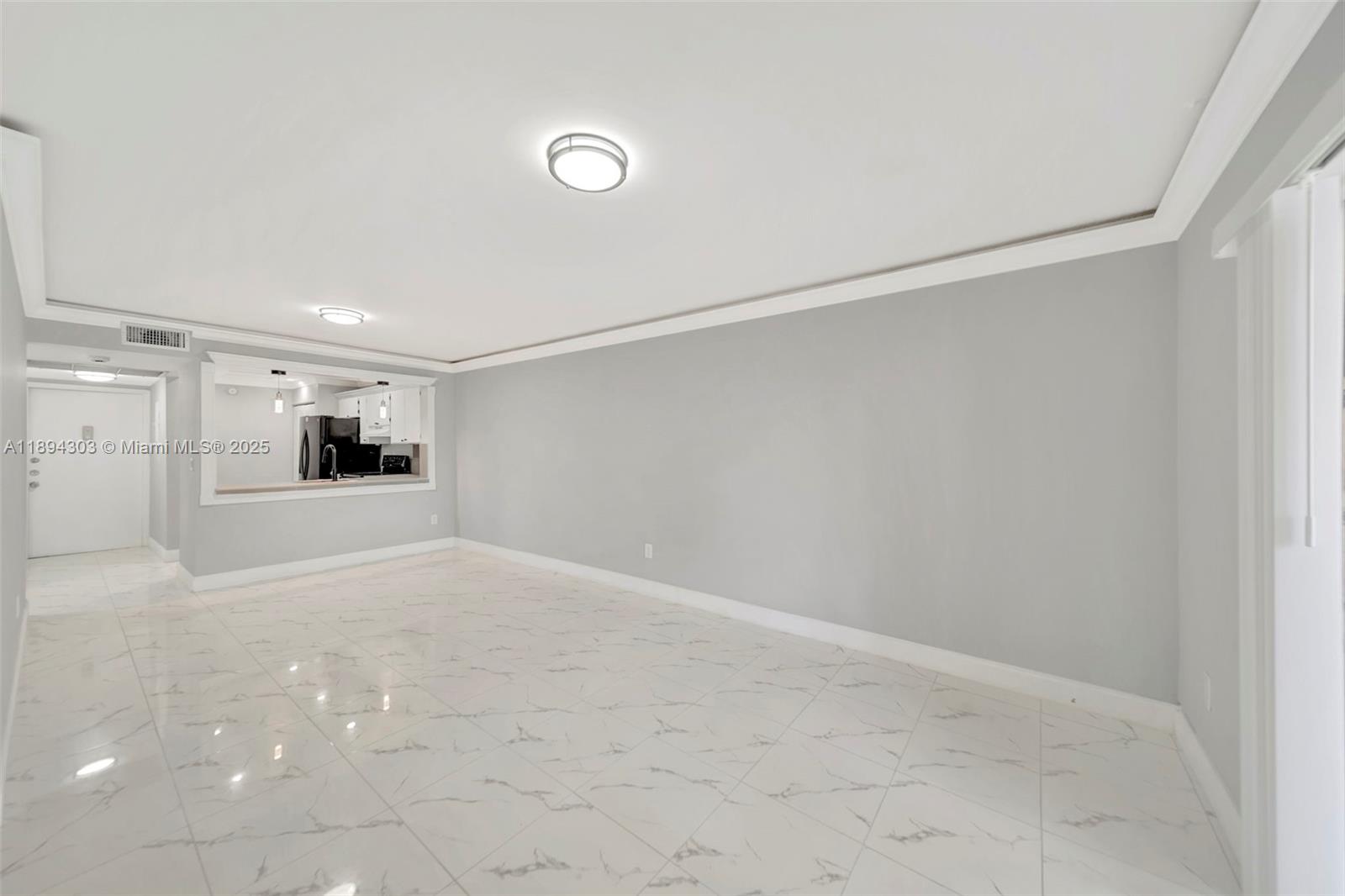 871 Northeast 207th Terrace, Unit 4202 Miami, FL 33179 - Photo 18 of 27 a view of a big room with wooden floor and windows