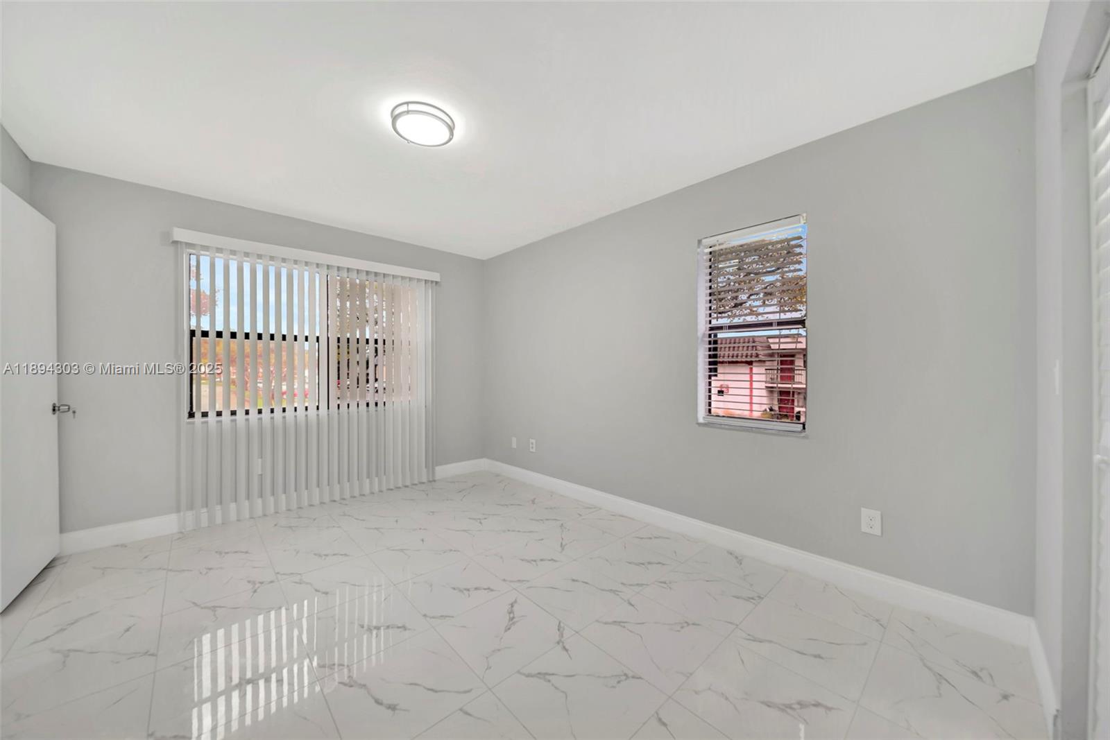 871 Northeast 207th Terrace, Unit 4202 Miami, FL 33179 - Photo 22 of 27 an empty room with windows