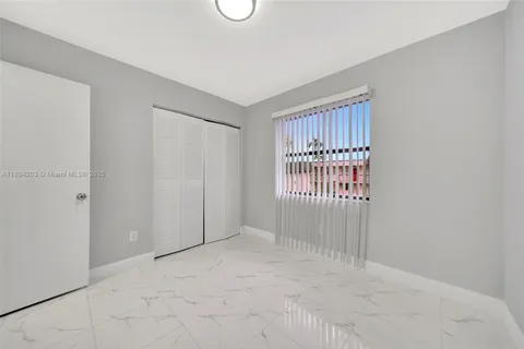 a view of a room with wooden walls and large windows