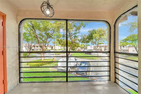a view of a balcony and car parked