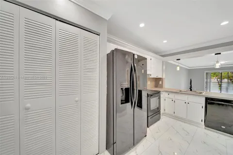 a kitchen with a refrigerator and a sink