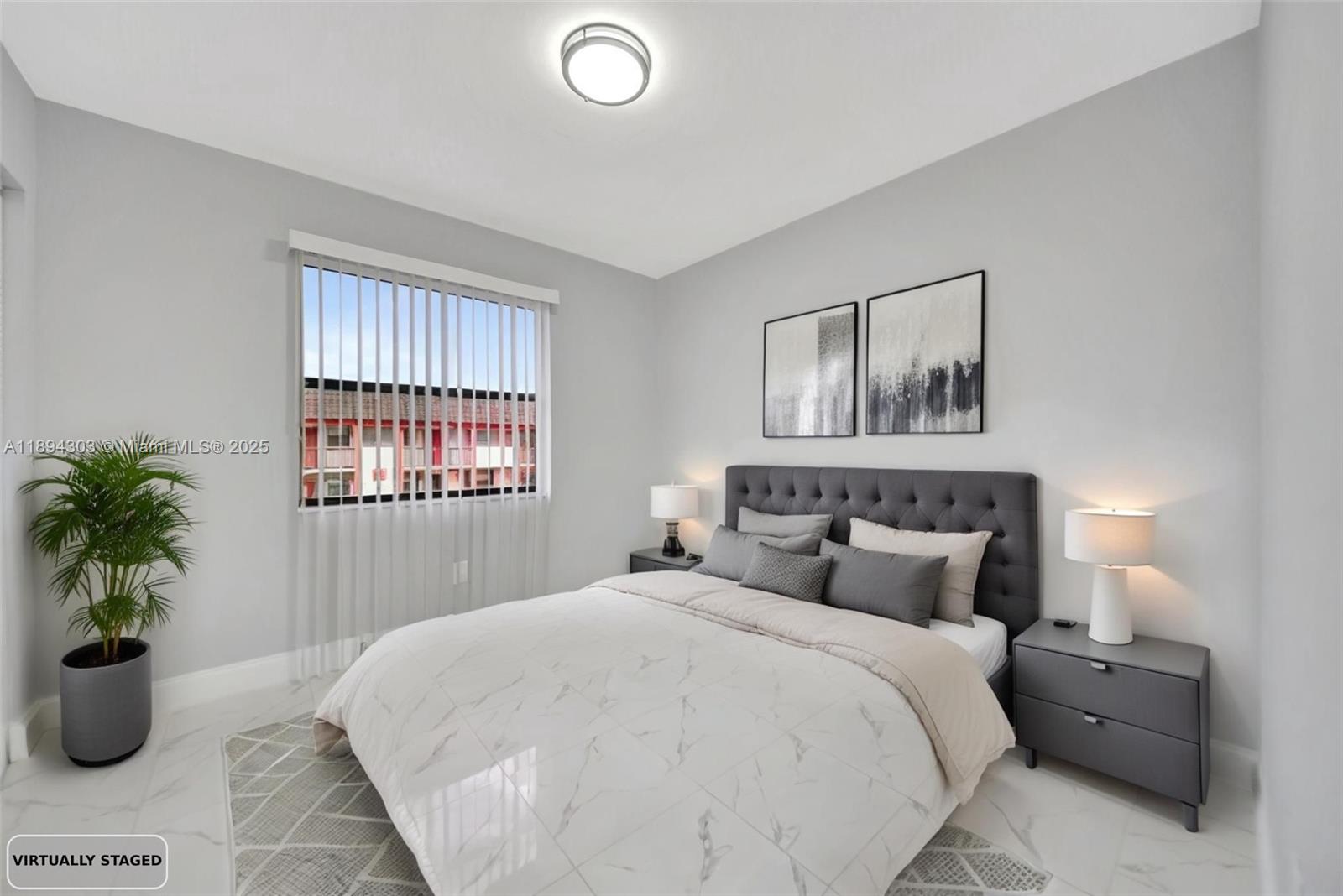 871 Northeast 207th Terrace, Unit 4202 Miami, FL 33179 - Photo 6 of 27 a bedroom with a large bed and a potted plant