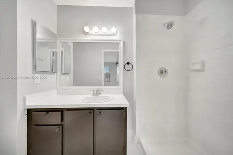 a bathroom with a sink vanity and a mirror