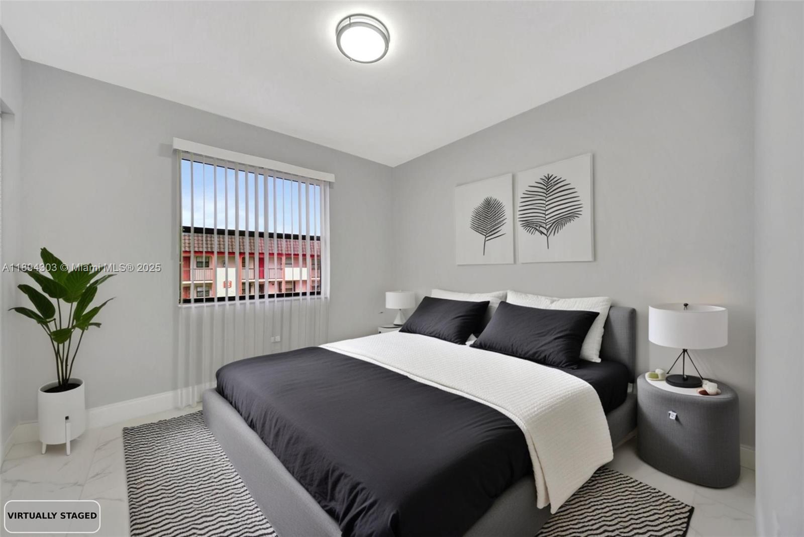 871 Northeast 207th Terrace, Unit 4202 Miami, FL 33179 - Photo 10 of 27 a bedroom with a large bed and a window