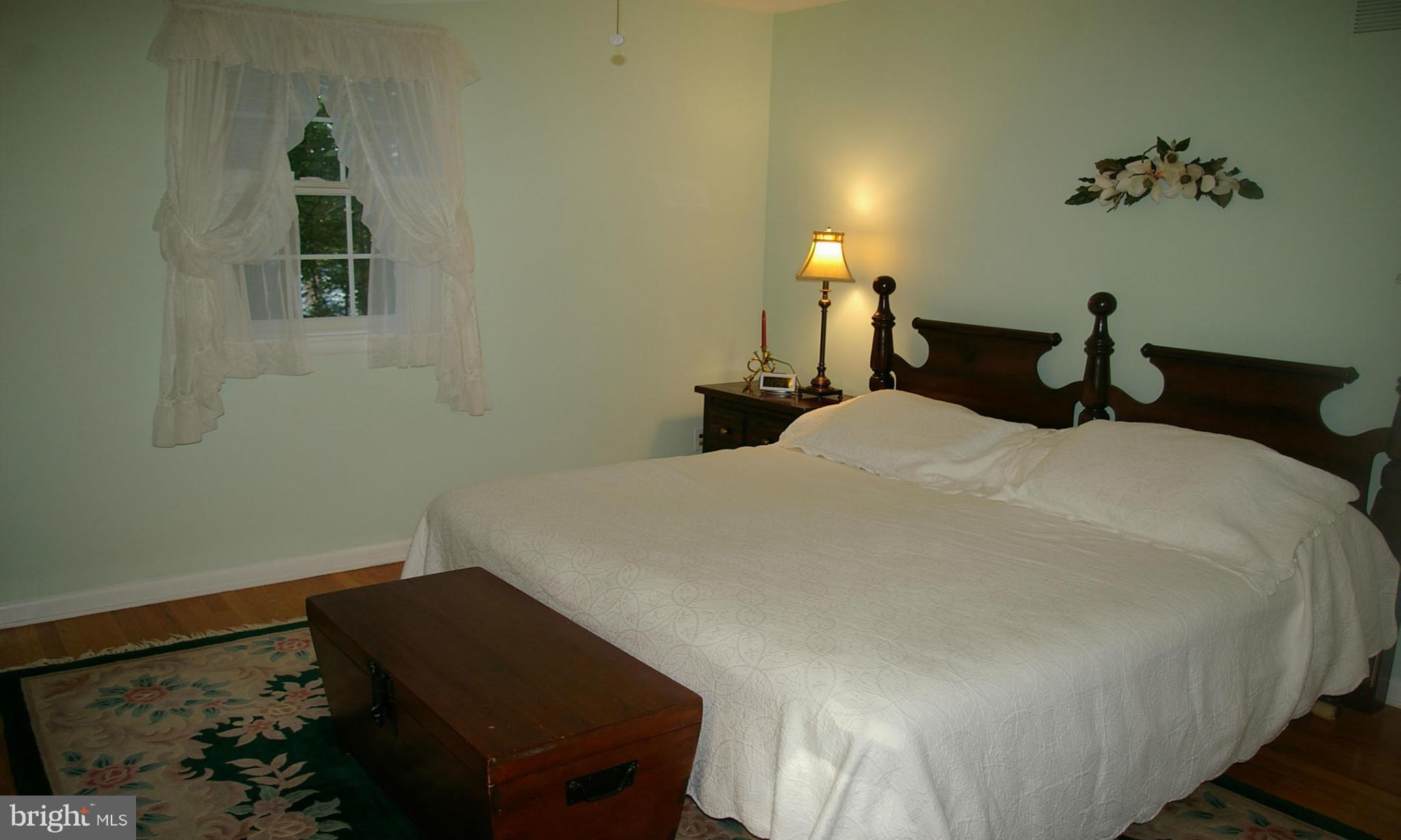 2012 Fallsgrove Way Fallston, MD 21047 - Photo 11 of 12 a bedroom with a bed and a lamp on the dresser