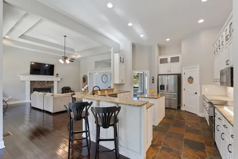 a bed sitting in a spacious bedroom next to a window