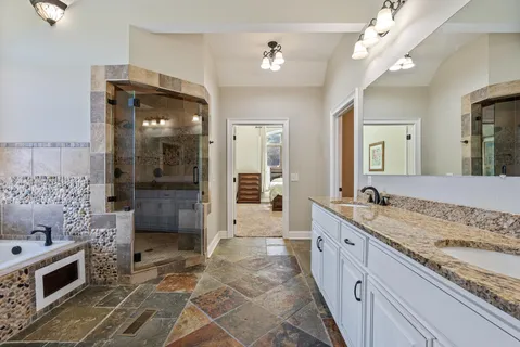 a bathroom with a granite countertop sink and a mirror