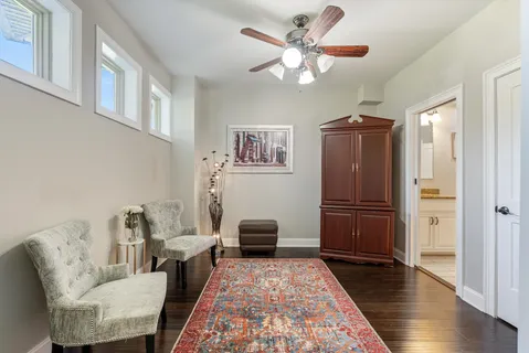 a living room with furniture and wooden floor
