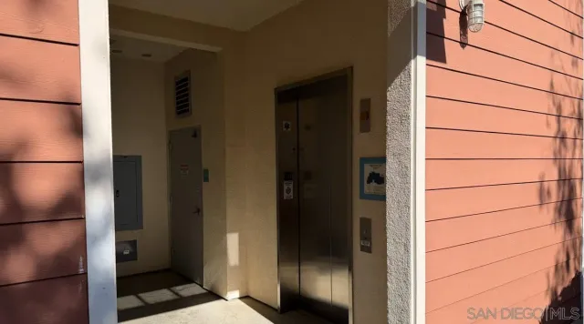 a view of a room with a chandelier and potted plant