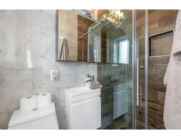 a bathroom with a sink toilet and mirror