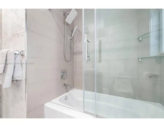 a bathroom with a bathtub and shower