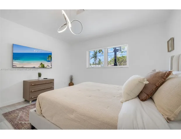 a bedroom with a bed and a painting on the wall