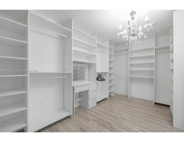 a room with kitchen island and wooden floor