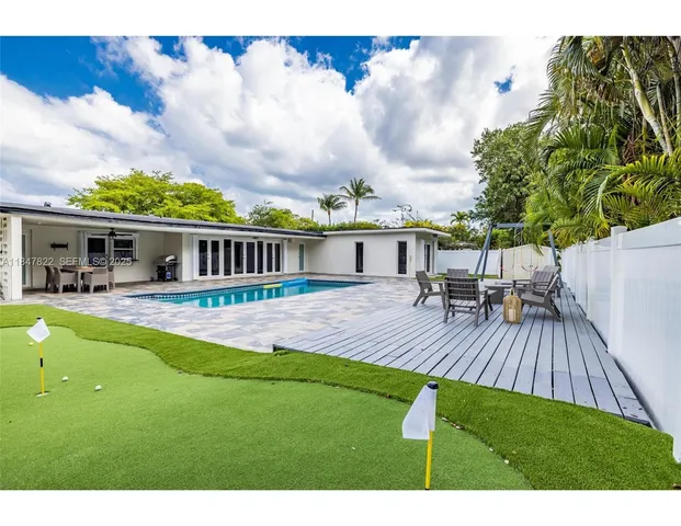 a view of house with swimming pool outdoor seating
