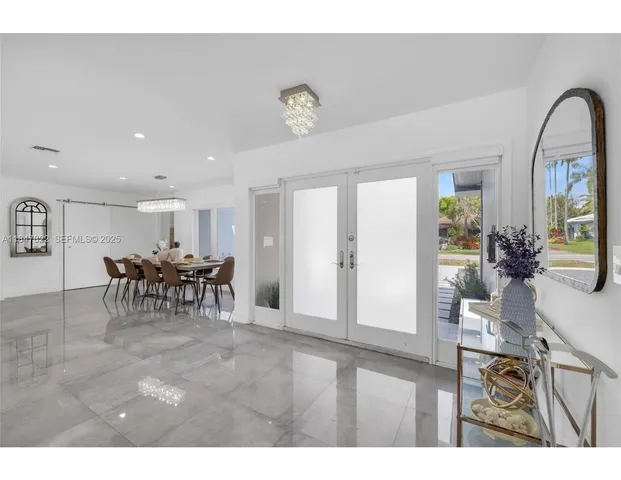 a view of a dining room with furniture and a chandelier