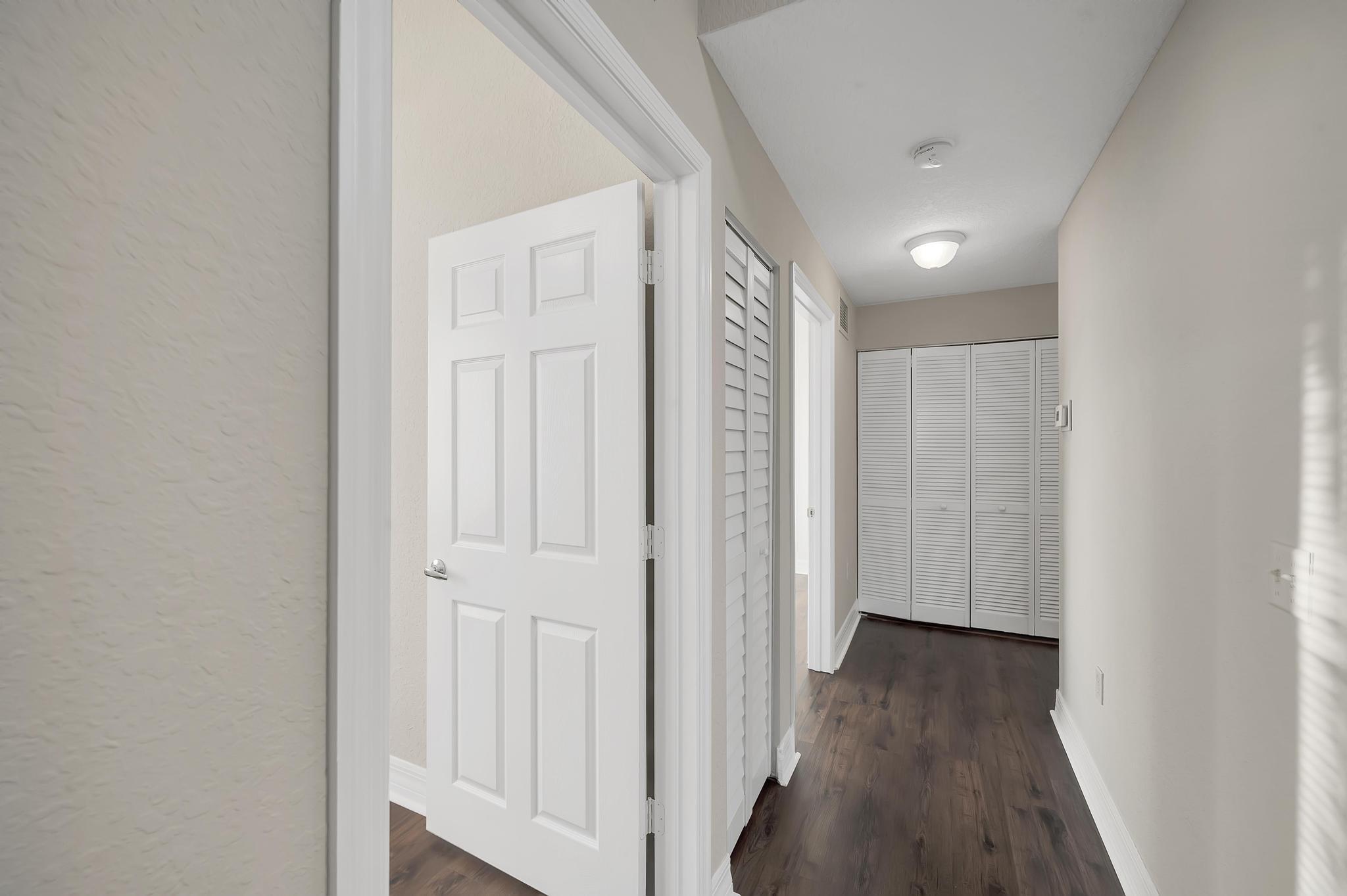 55 Southeast Palermo, Unit 106 Stuart, FL 34994 - Photo 20 of 39 a view of a hallway with wooden floor