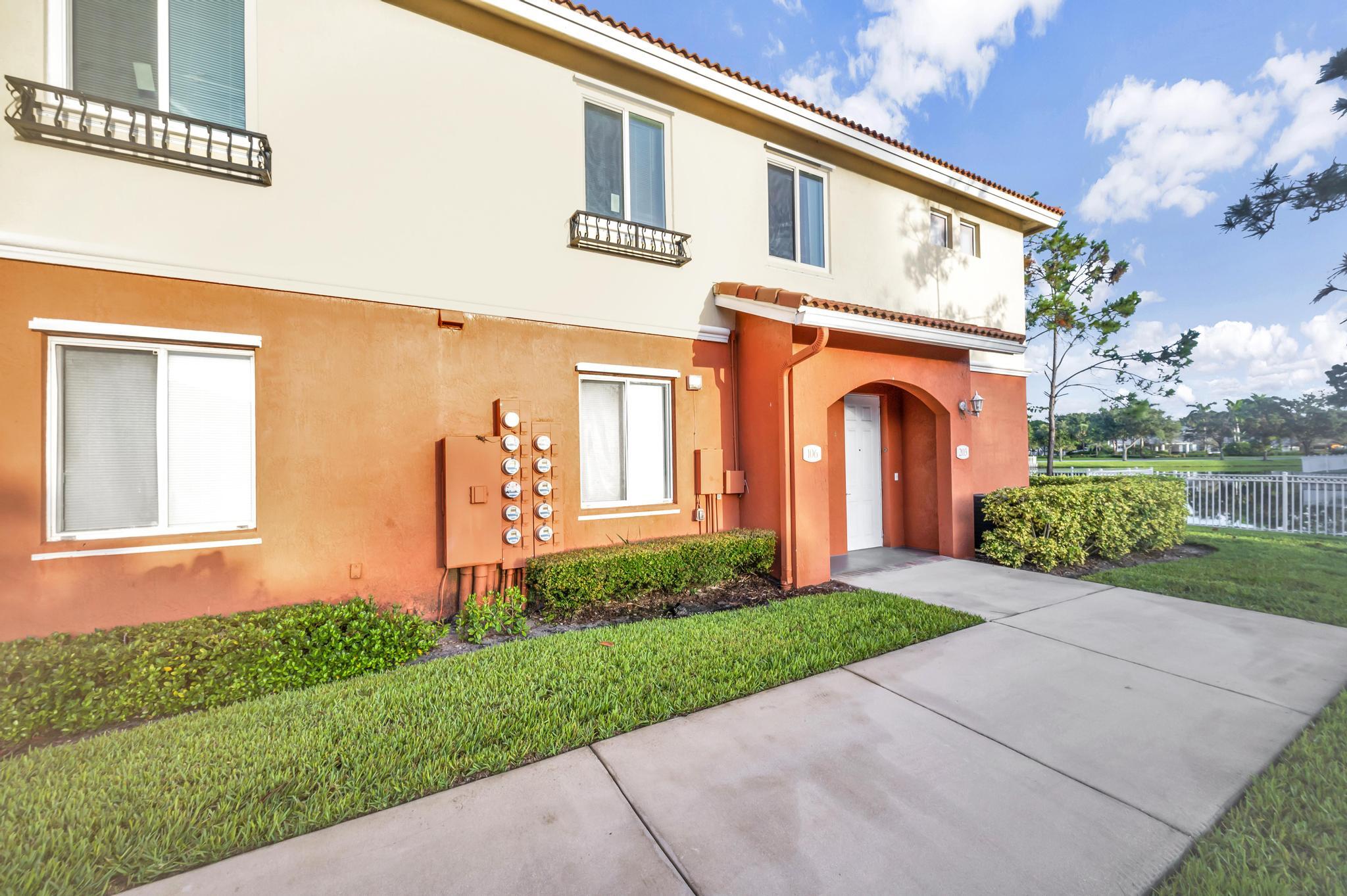 55 Southeast Palermo, Unit 106 Stuart, FL 34994 - Photo 29 of 39 a front view of a house with garden