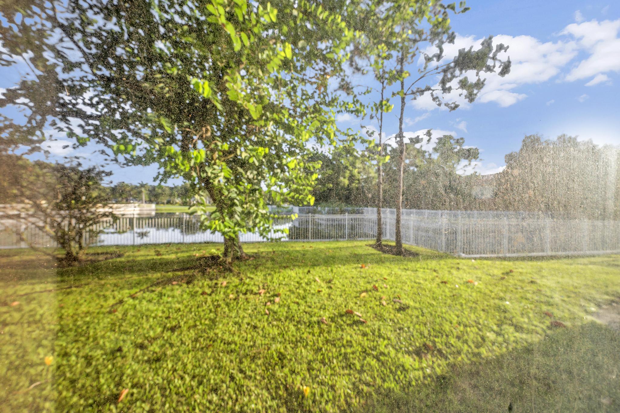 55 Southeast Palermo, Unit 106 Stuart, FL 34994 - Photo 34 of 39 a backyard of a house with lots of green space