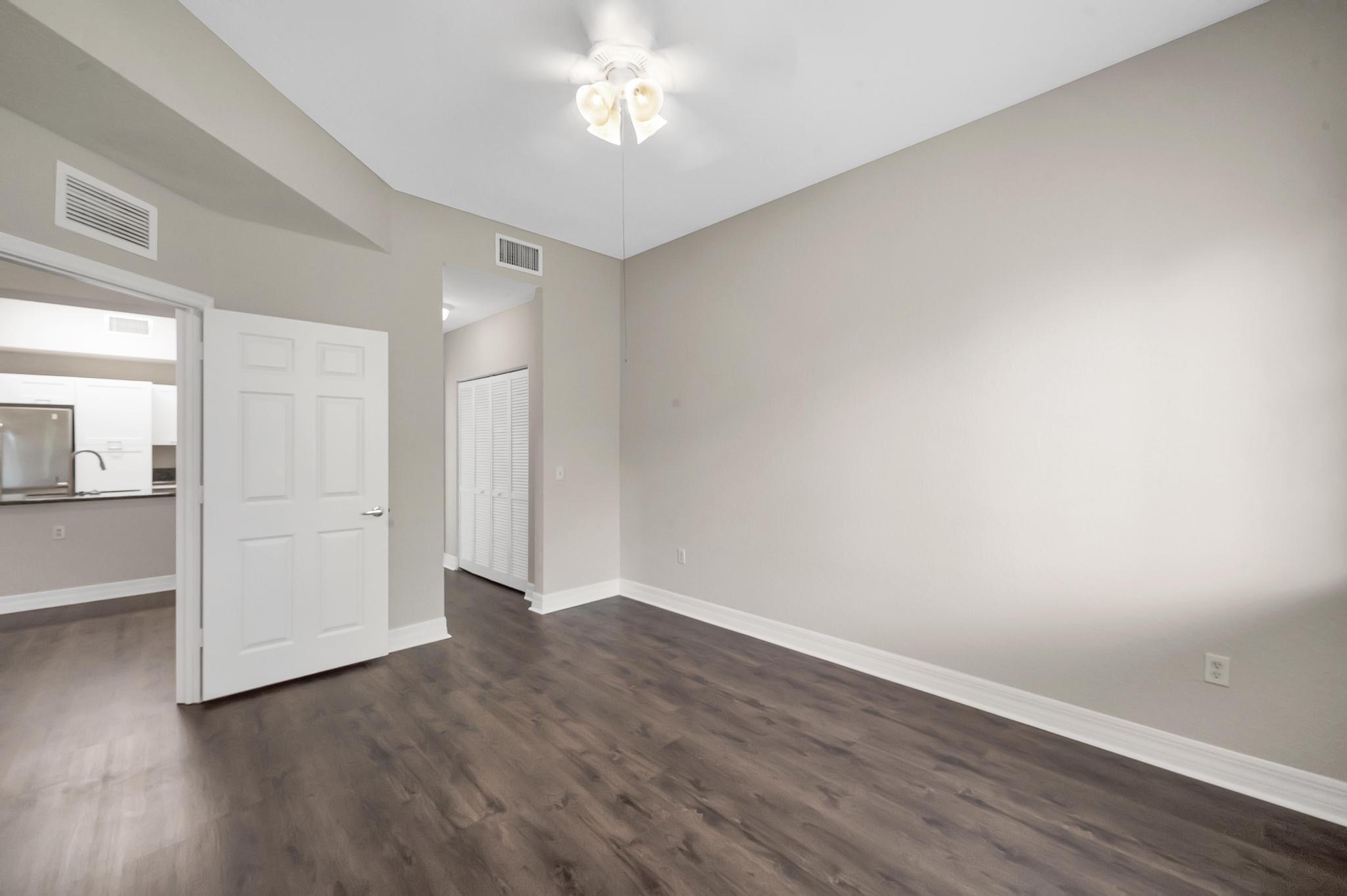 55 Southeast Palermo, Unit 106 Stuart, FL 34994 - Photo 9 of 39 a view of an empty room with wooden floor