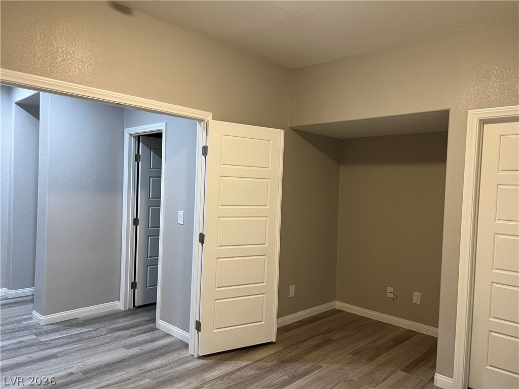 5981 Honeysuckle Ridge Street Las Vegas, NV 89148 - Photo 7 of 29 The generously sized interior with rich wood flooring awaits your personal touch.