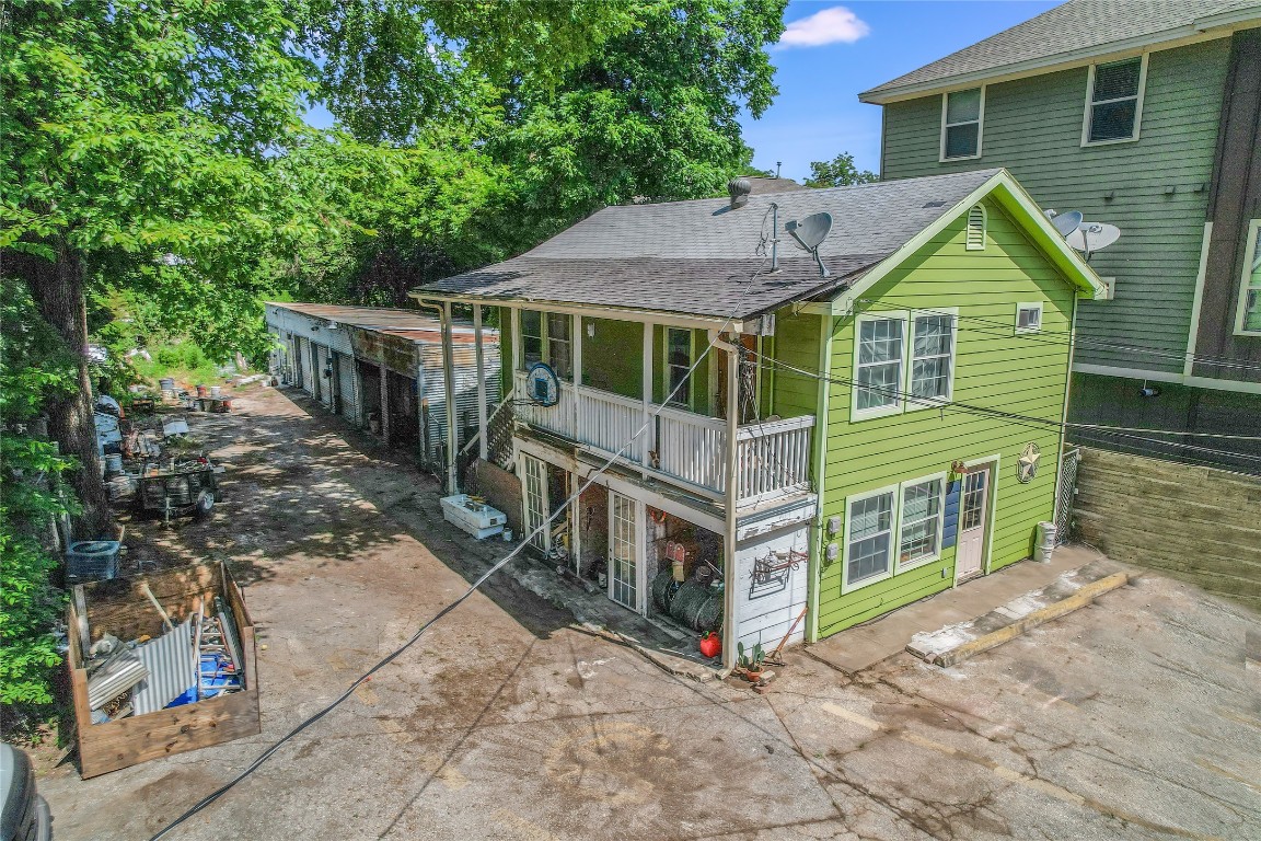 602 Allen Street Austin, TX 78702 - Photo 2 of 4 Rear view of property with roof with shingles and a balcony