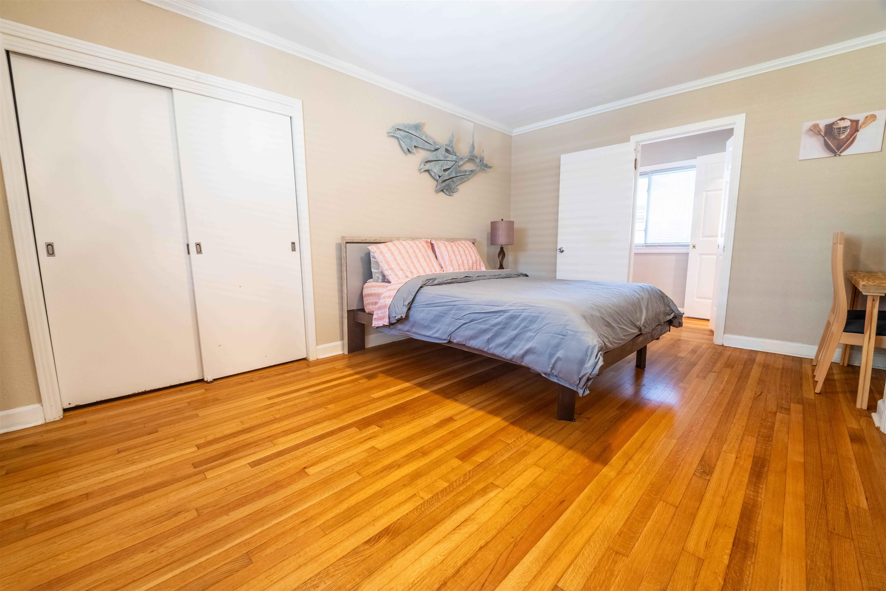 5099 Walnut Grove Road Memphis, TN 38117 - Photo 16 of 24 Bedroom with light wood-style flooring, ornamental molding, and a closet