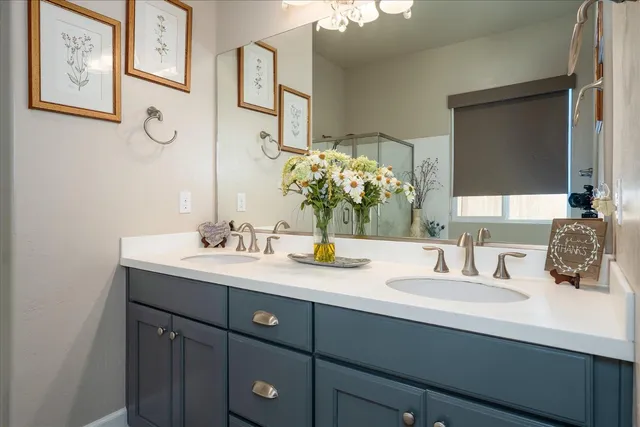 a bathroom with a double vanity sink and a mirror