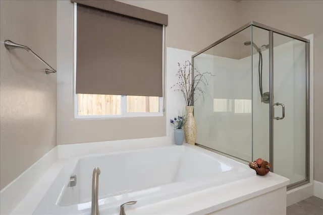 a bathroom with a tub and a shower