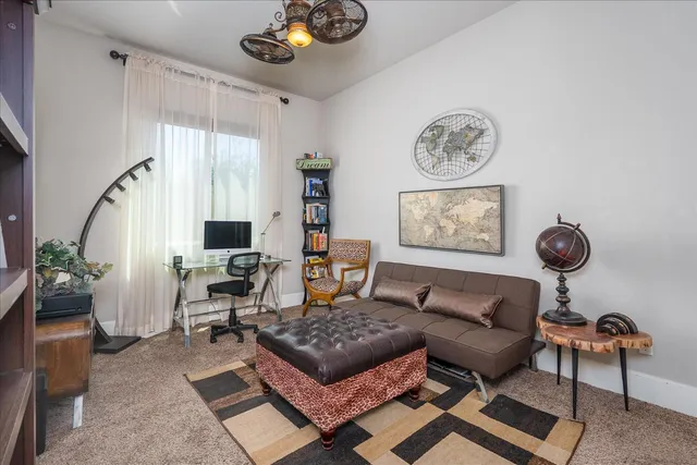 a living room with furniture a rug and a window