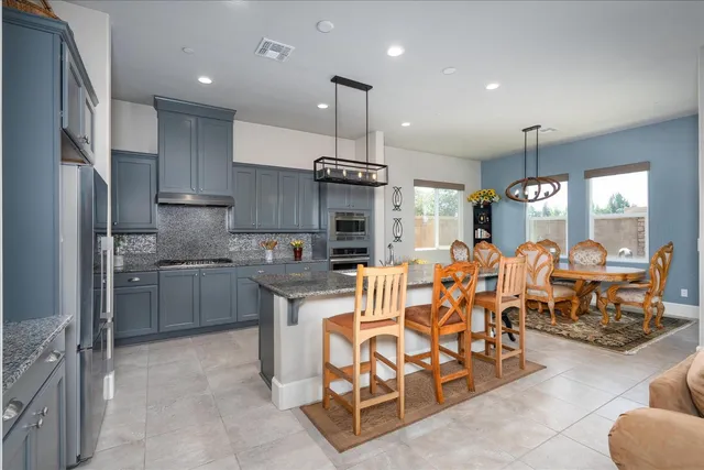a large kitchen with a table and chairs