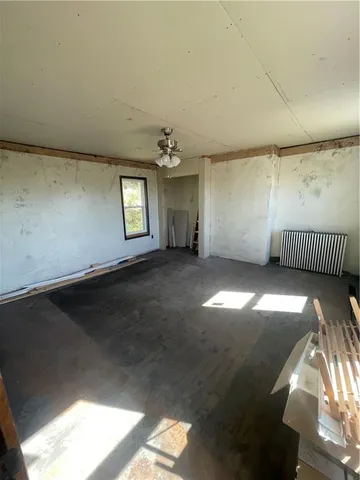 a view of room with window and ceiling fan