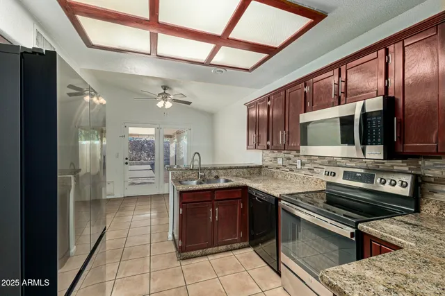 a kitchen with a sink stainless steel appliances and cabinets