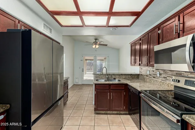 a kitchen with stainless steel appliances granite countertop a stove and a refrigerator