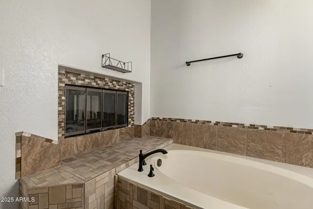 a bathroom with a bathtub and a shower